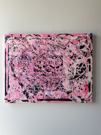 a pink and black painting on a white surface