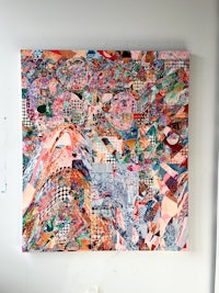 a piece of art hanging on a wall in a room