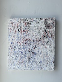 a painting with red, white and blue paint on a white surface