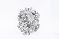 a sculpture made of pieces of metal on a white background