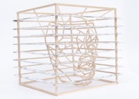 a wooden crate with a wooden head on it