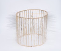 a wooden basket with feathers in it